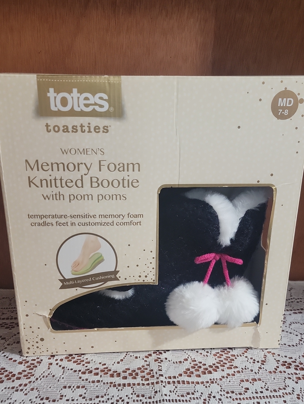 totes Toasties Women's Black Memory Foam Knitted Bootie with White Pom Poms